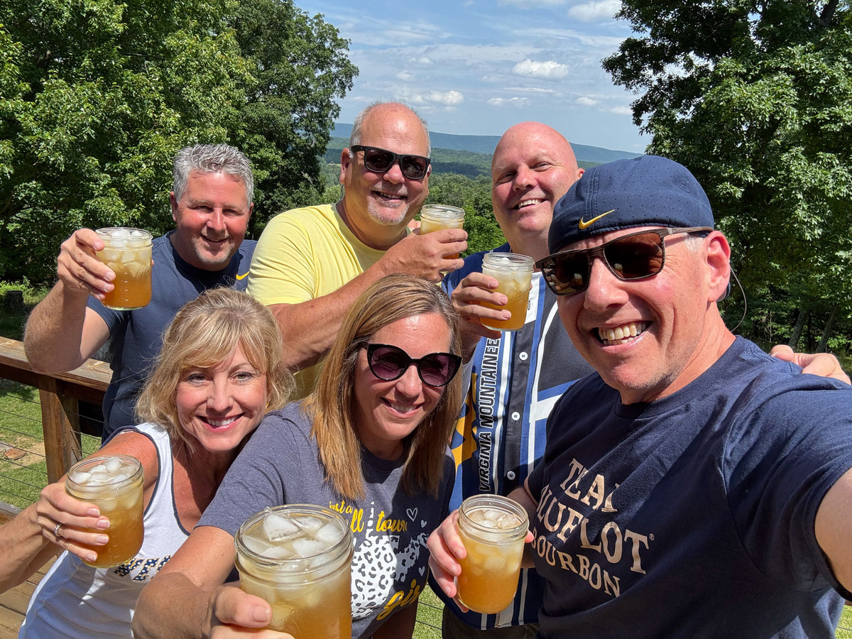 Friends gathered outdoors at a Blue Lot® tailgate.