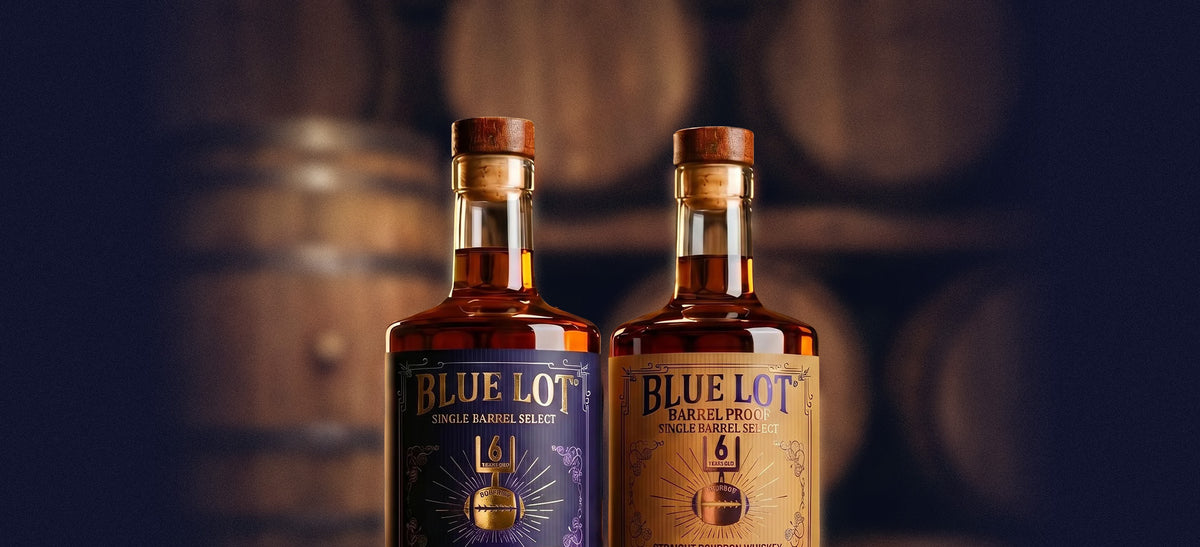 Two Blue Lot® bourbon bottles displayed in front of stacked barrels.